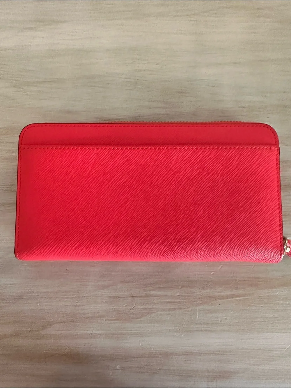 kate spade saffiano zip-around wallet in vibrant red with gold plaque